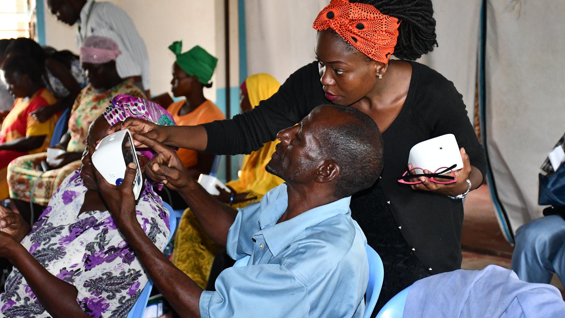 Community health worker being trained in how to use the medical device